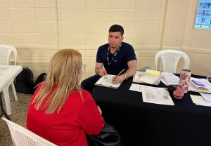 A medical worker asks a patient about their medical history.